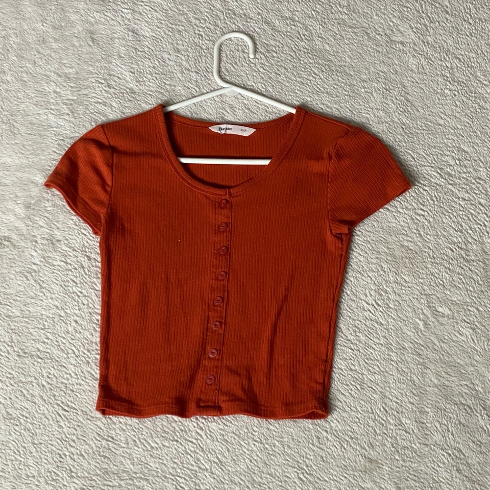 Button but orange shirt